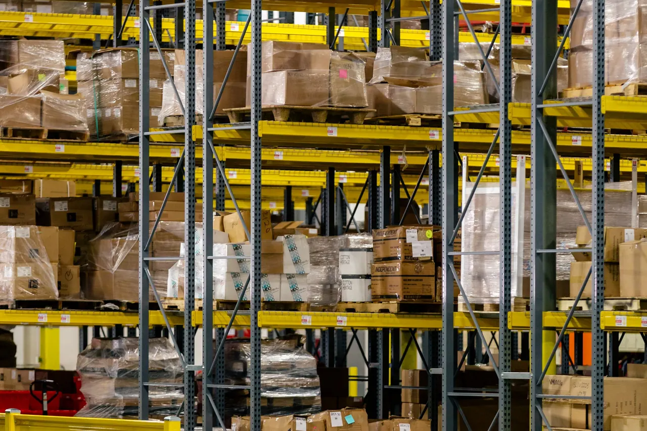 Warehouse shelving stocked with boxed inventory